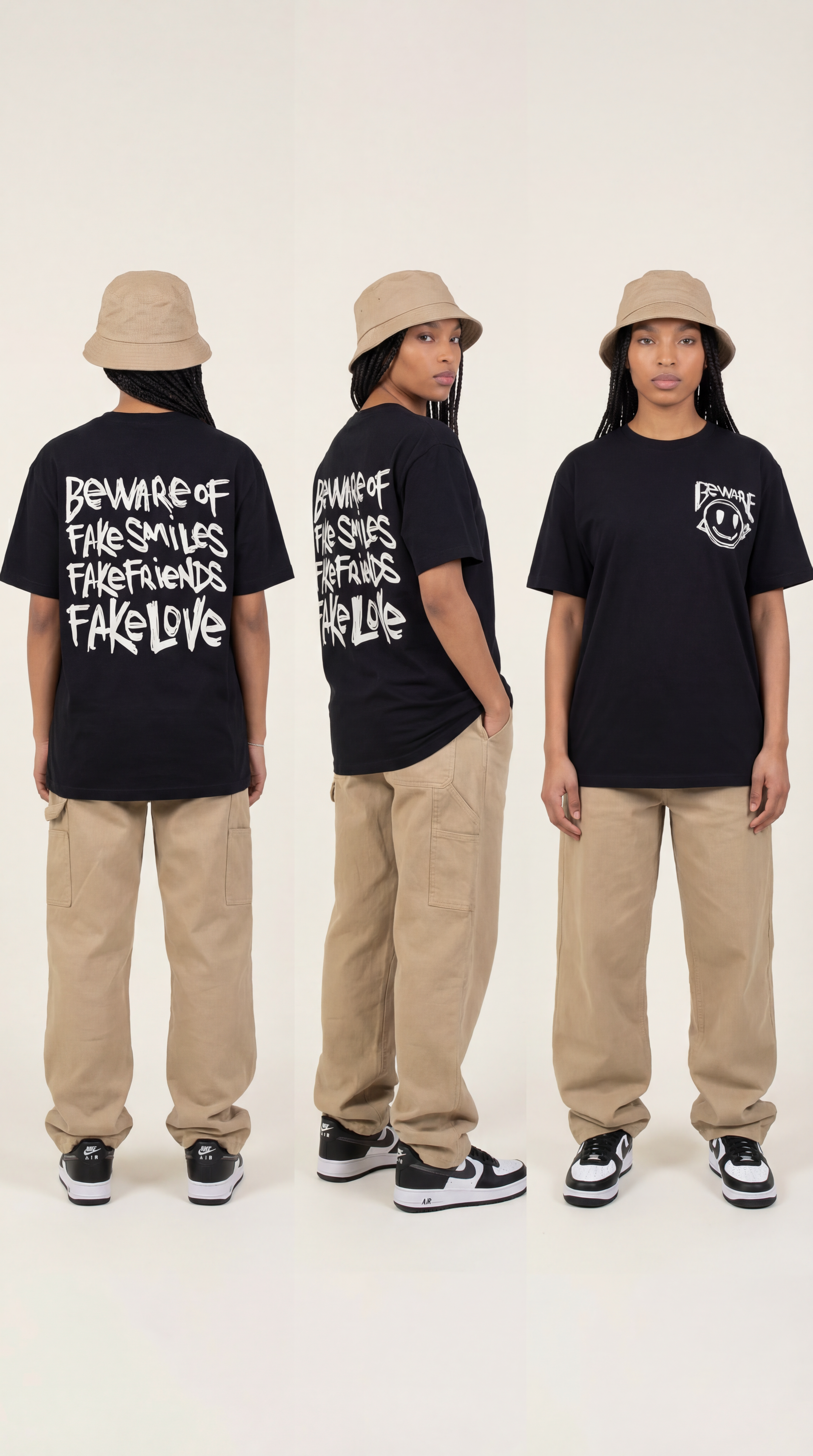 Three Black women wearing the LOVEUS "Beware of Fake" black graphic t-shirts, styled with braids and bucket hats against a white background.