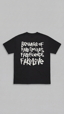 LOVEUS "Beware of Fake" Heavyweight Graphic T-Shirt in black. Back view against white background.