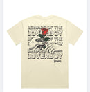 The back view of the beige Beware of the Loverboy Heavyweight Tee displayed flat on a white background, highlighting the large statement rose graphic.