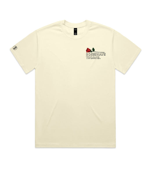 The front view of the beige Beware of the Loverboy Heavyweight Tee against a crisp white background, showcasing its clean neckline and relaxed streetwear silhouette.
