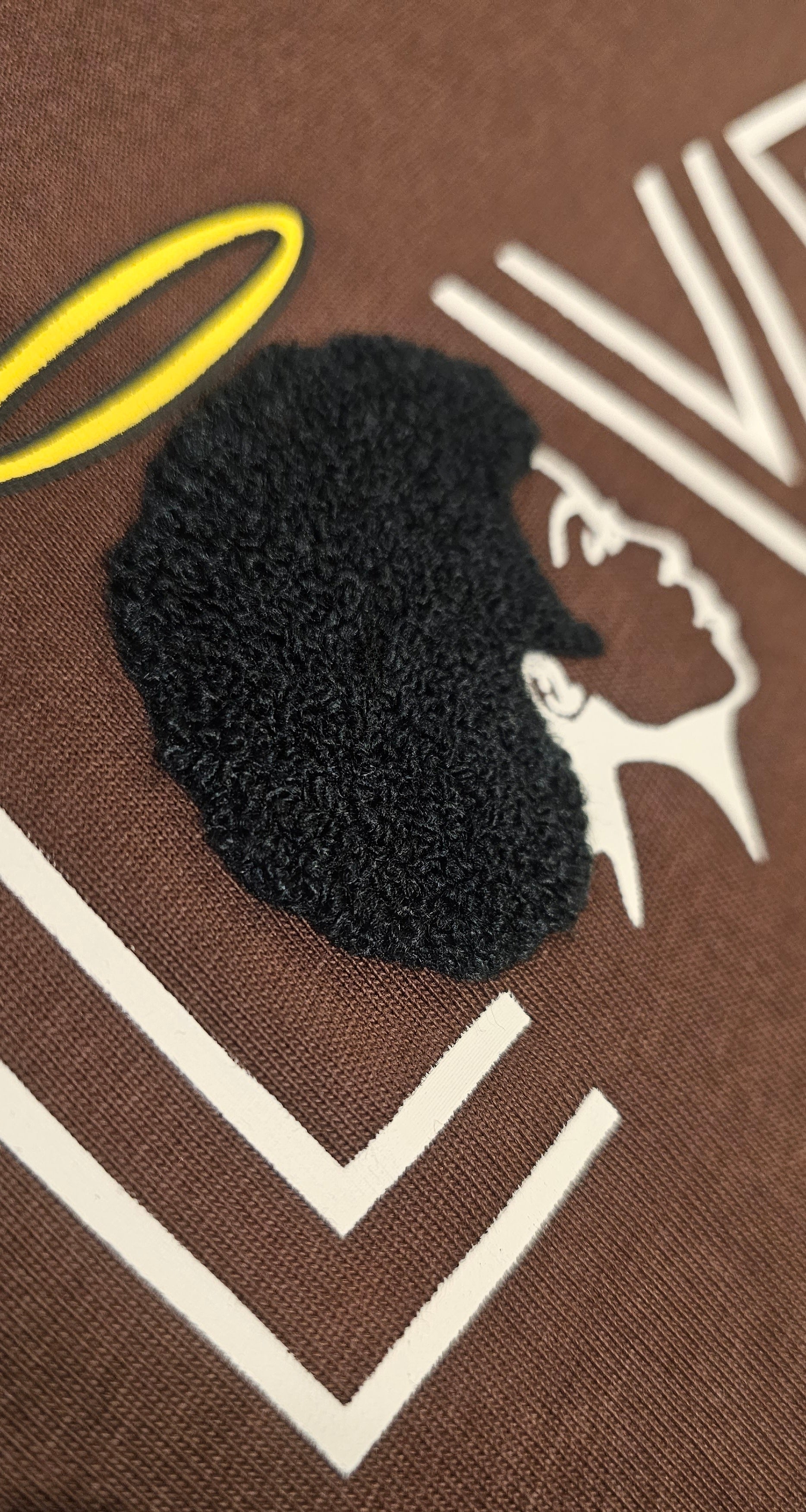 A detailed close-up shot highlighting the premium, raised embroidered texturing on the brown Chocolate Angel Embroidered Cotton Shirt.