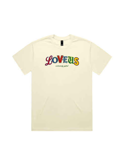 A flat-lay view of the beige Extremely Gifted Heavyweight Graphic Tee on a clean white background, highlighting the colorful abstract text design and premium cotton texture.