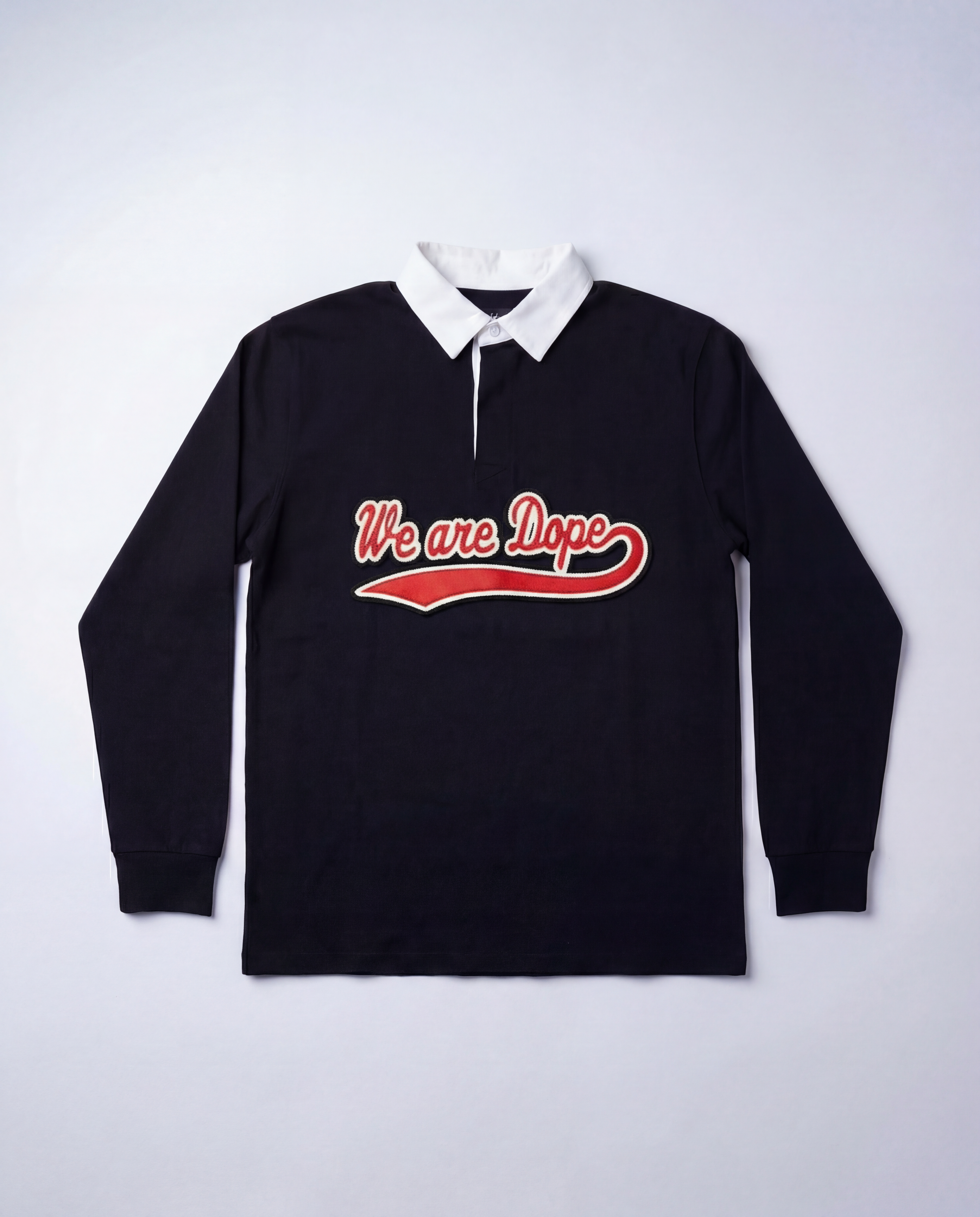 A detailed studio product shot of the black Loveus We Are Dope Cursive Rugby Polo against a clean white background, highlighting the crisp white collar and the premium red cursive tackle twill lettering.